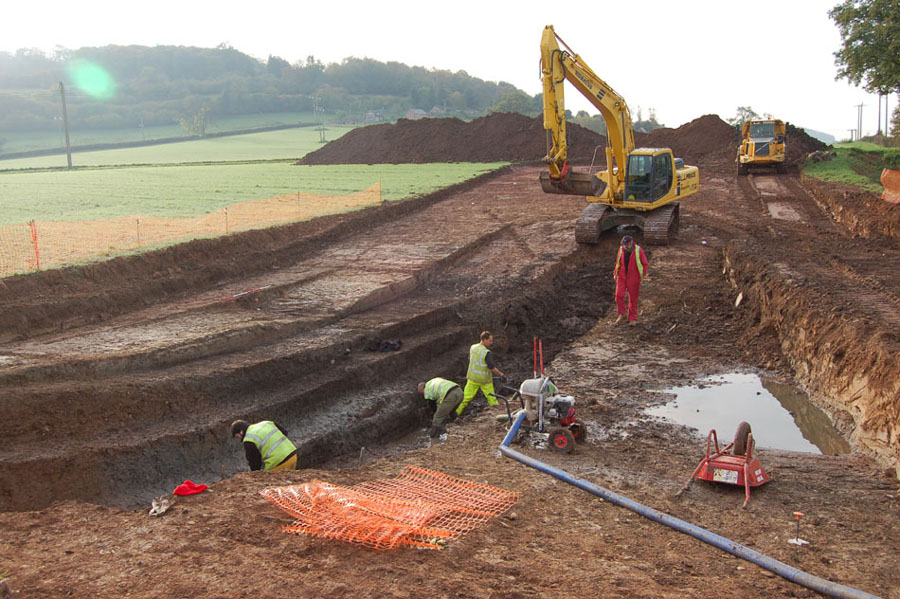 Recent excavation by the Worcestershire Historic Environment and Archaeology Service on the northern slopes of Dinedore hillfort, here a paleochannel being excavated, the C14 dates from the base indicate Bronze Age (c.1700BC), and from the top the time of the Conquest (c.1100 AD). Dinedore fort in the background, to the left of the photo, facing southwest.