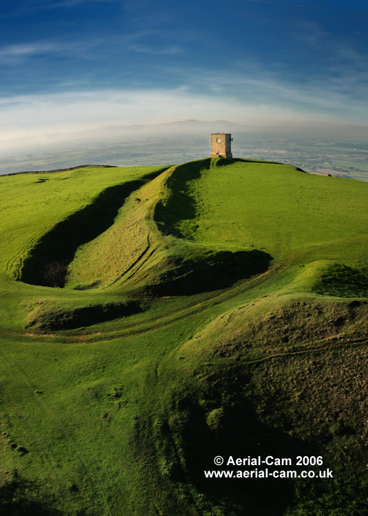 Kemerton Camp the main hillfort on top of Bredon Hill, Worcestershire. There is another Iron Age enclosure on the sourthern slope called Conderton Camp and another possible at Elmley Castle.

Kemerton Camp is a promontory fort with a steep escarpment dropping away on the north side of the  Hill, it has two sets of ramparts and ditches to the south. The inner ramparts possibly date to 300BC.

T