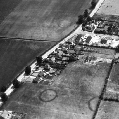 Harrold Barrows These revealing aerial photos were taken over my village during the 1960s. They show the cropmarks of four burial mound ring ditches in Harrold, Bedfordshire.
Archaeology reports indicate that there were up to 18 barrows discovered when gravel extraction took place during the 1950s, located at what is now Meadway, Harewelle, and the Country Park. The topsoil was removed, which is when the rings