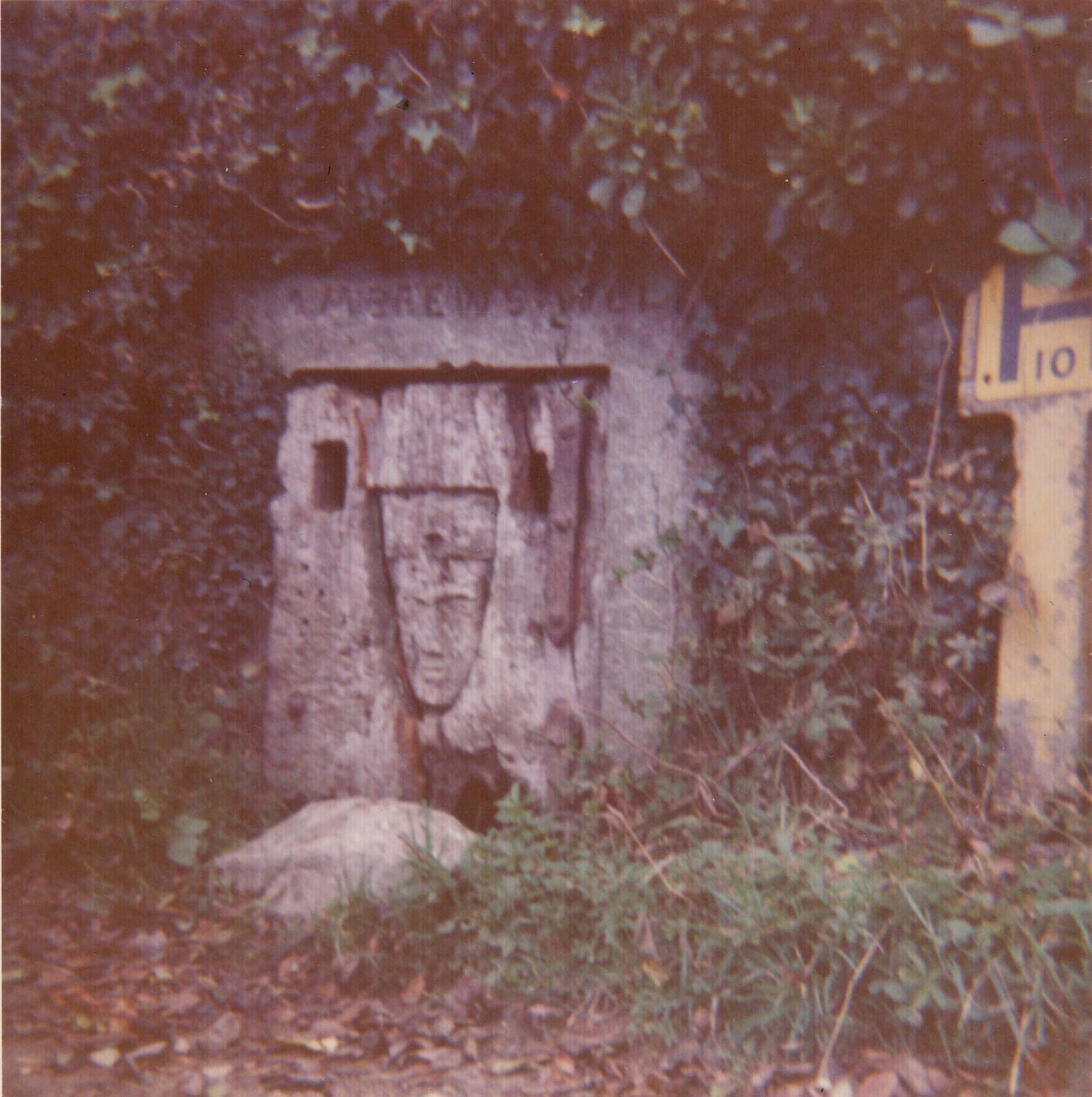 I took this photograph in the 1970's. The doorway is damaged, with a large hole at the bottom and the wood is split down one side.