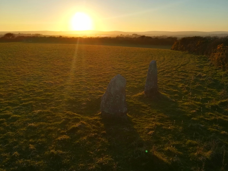 Standing Stones inside Faughan Settlement and the Setting Sun, You can easily see the slope of the inner enclosure 