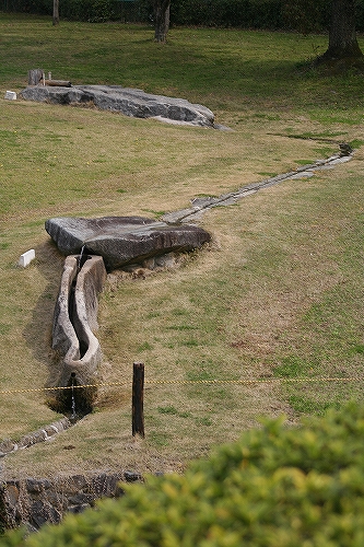 Site in Honshu, Japan. The replicas of Sakafune-ishi and Demizu-no-Sakafune-ishi, water is running through them. 
