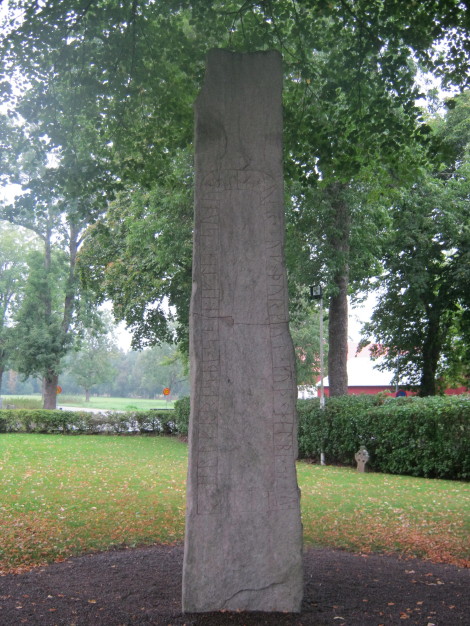Photographed in the rain in September 2011.  A very tall rune stone in the grounds of the Levene church.