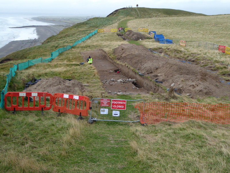 Overview of the excavation site on the evening of the end of the dig.  Two massive trenches, and researchers from Aberystwyth Luminescence Research Laboratory are hard at work collecting sand core samples for dating, before the covering up of the stones and backfilling the following day.