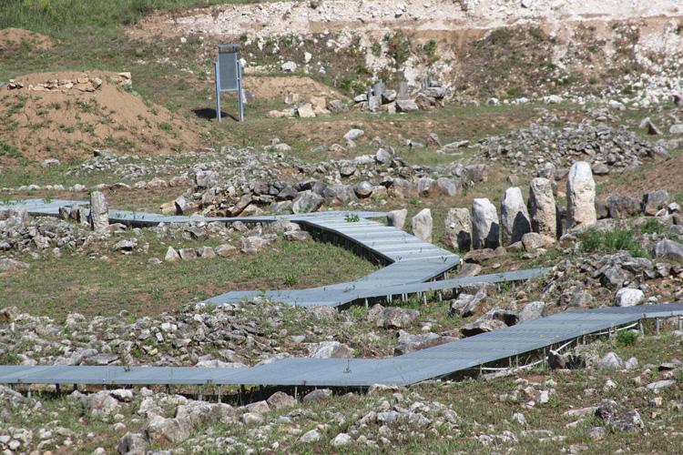 View through the fence at Fossa. You can see that they are building walkways among the stones. I suspect that a lot of damage happened during the 2009 earthquake near L'Aquila.