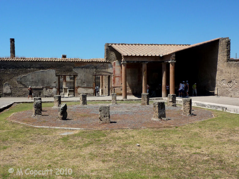 A circle of 12 volcanic tuff stones erected in the central Macellum of the ancient city of Pompeii. 