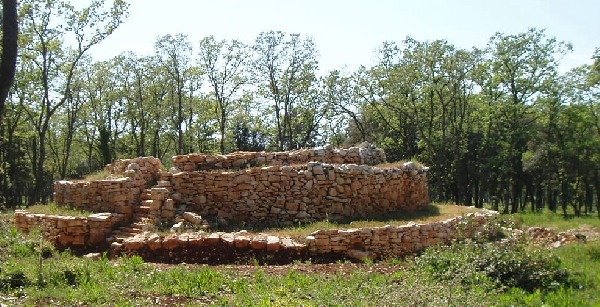 Uvala Maric Zigurat4 Tiered Zigurat with steps on East side. The 8 Barbarija tumuli, as well as the 3 Uvala Maric Zigurats were on the estate of the Dragonera Roman Villa, close to the Adriatic Sea.This site was recently excavated by Pula Museum Archeologists. It continues to puzzle them as the stone monument is of an archaic type, yet has some Roman potery shards, as well as pre-roman shards in i