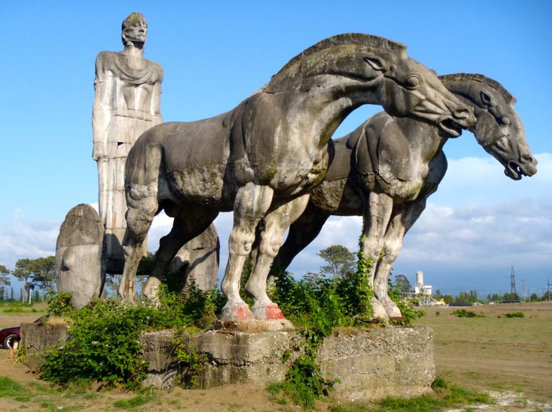 This enormous cement sculpture of a chariot rider and two horses guards what once was the entrance to the ancient bronze age site of Pichvnari. Built in the 1960s during the Soviet era. Picture taken in 2011.