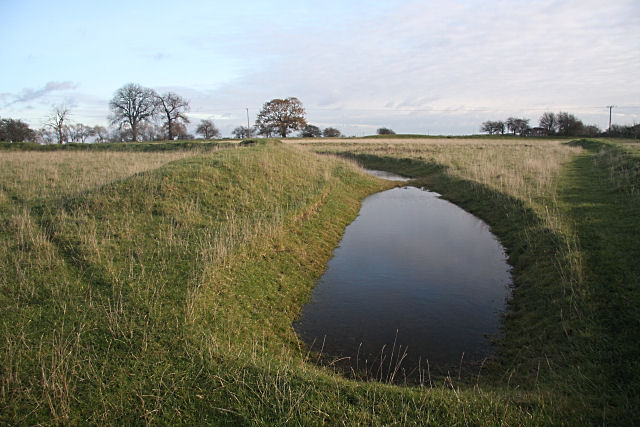 Stonea Camp ditches. Stonea Camp is the lowest 'hill fort' in Britain. Extensive banks and ditches protected its northern side, while the marshes and streams of the Fens formed the southern defences. Built by Britons in the Iron Age as a base for inter-tribal conflicts, the fort was also used to defend the area against the Romans. Most of the earthworks visible today were rebuilt in 1991 to their 