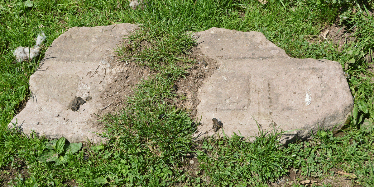 The large lump of what looked like stone with some sort of architectural design on it, just by the gate into the field.