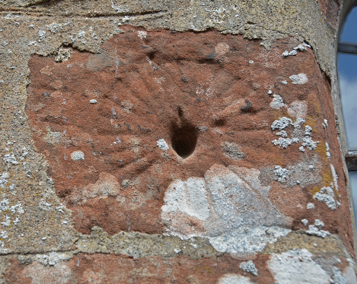 Close up of the sundial at the top of the western jamb of the middle window on the south side of the chancel.  It is recorded on the Corpus of Anglo Saxon Stone Sculpture as Isel 05, 'presumed to be of pre-Conquest date'.  

The sign in the south porch reads: 