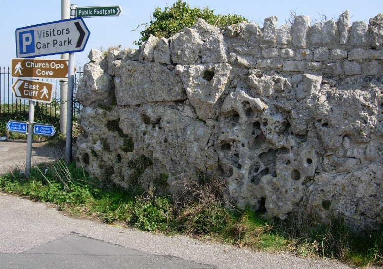 The scene that greats you as Grove Road terminates with this wall - composed of extremely weathered, unusual stones - possibly once part of a Portland Stone Circle. See main entry for more details.