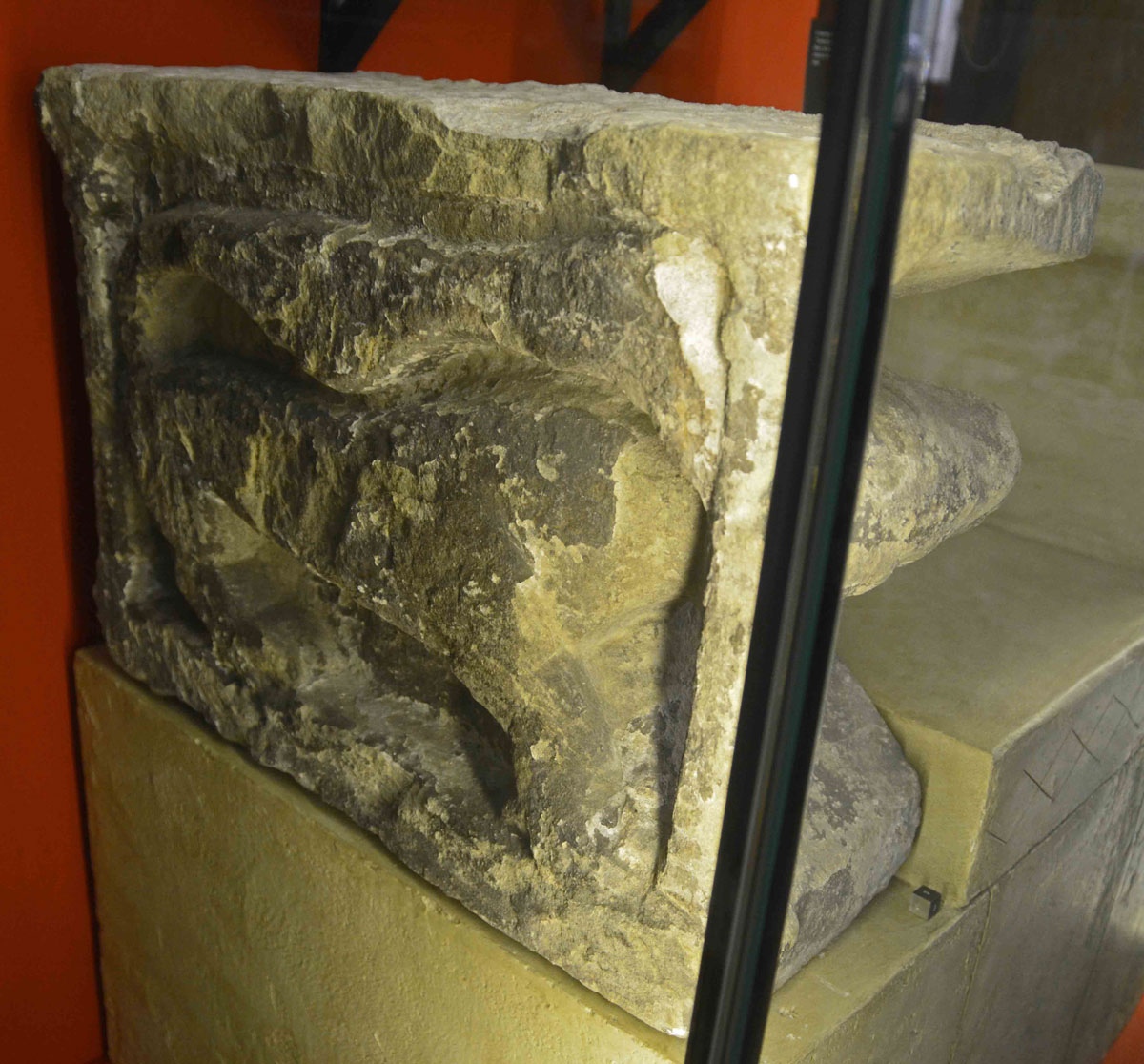 This is Monkwearmouth 15a, an original part of the Abbot's Seat, recorded as AS Corpus's Monkwearmouth 15a-b (Displayed behind glass in the Exhibition Centre - not much room between the cabinet and the wall to photograph it properly!). It is described as a 'lion in an architectural cage', meant to be seen from the side and the front. Dates to the last quarter of the seventh century. 