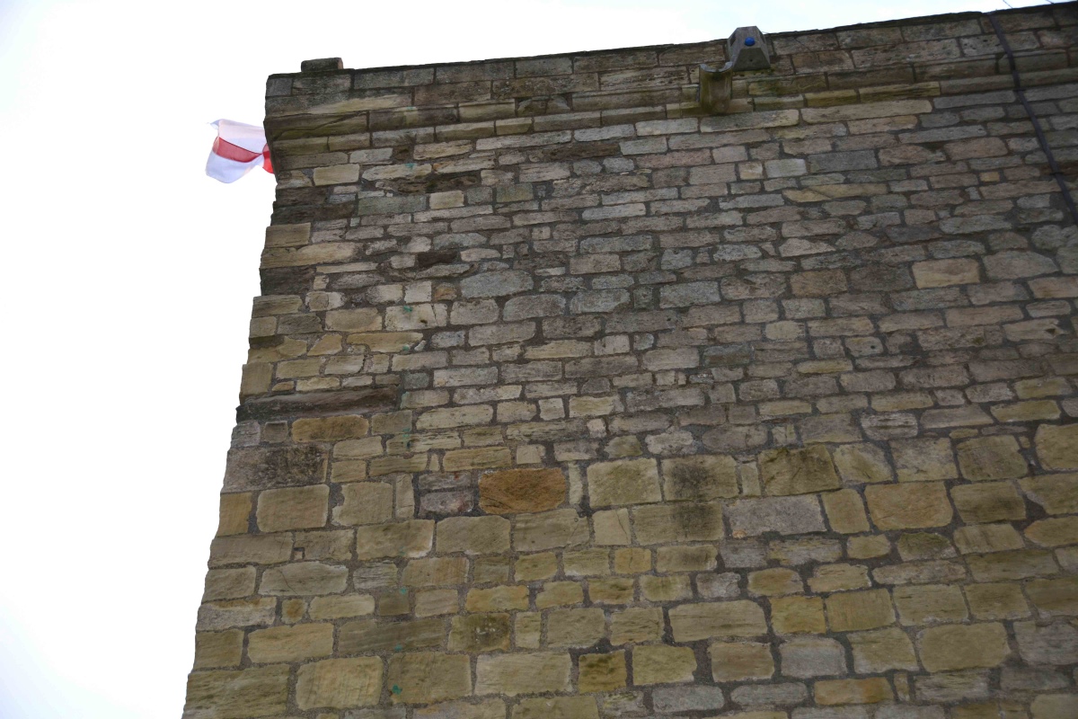 In the different corners of the tower (externally), Poinds (Gazetteer of Anglo Saxon and Viking Sites: Northumberland and County Durham), page 186, described grave covers which have been incorporated into the quoining.  After a closer look (in the biting winter wind), my husband, who is a civil engineer, thought they were far too thick for grave covers, and were just larger stones to tie the sides