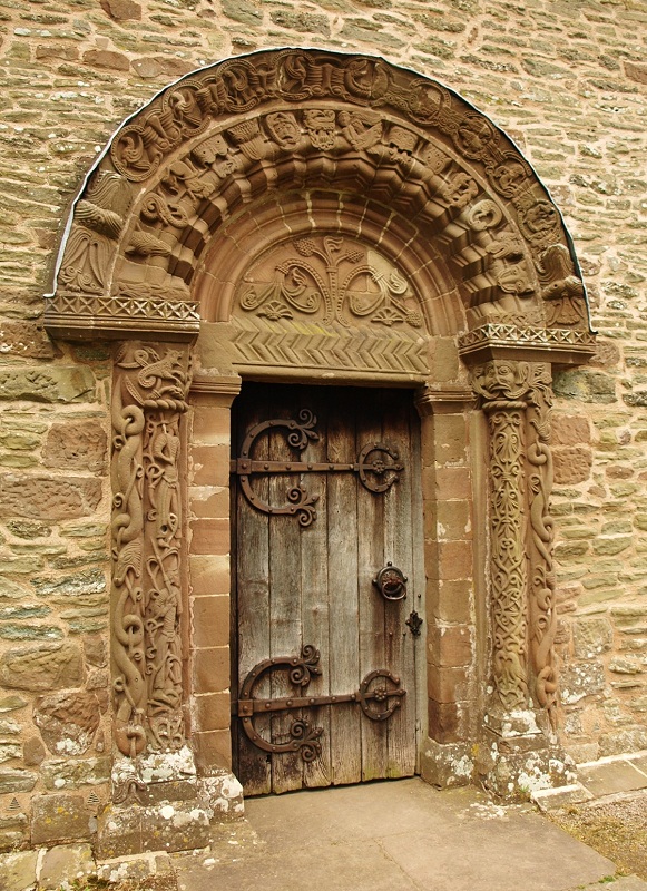 The entry of Kilpeck Chruch.  A wooden porch (not original) that covered this doorway for a period of time it thought to have helped protect the carvings.
Photo by bat400, 2014.