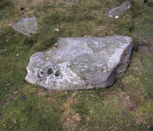 Addlebrough cairn, nr Aysgarth, N Yorks -SD94598812

The simplest of the 3 carvings in the cairn, just 3 cups.
