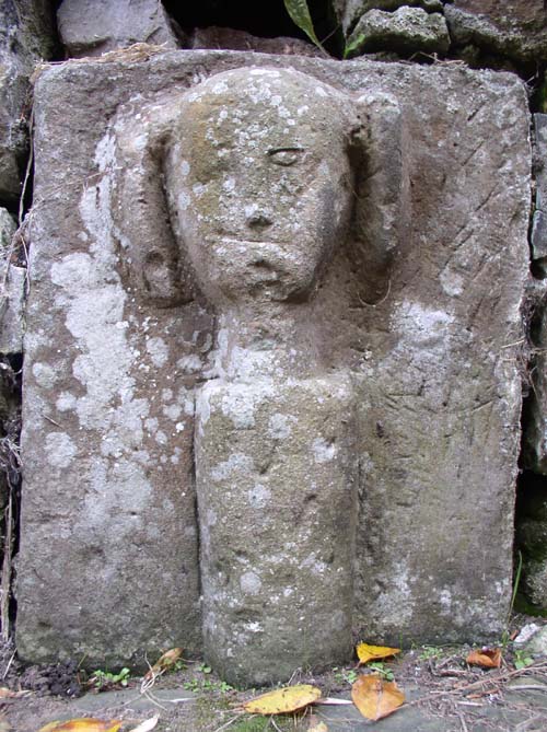 A close up of the Celtic Head in Rostherne Churchyard.