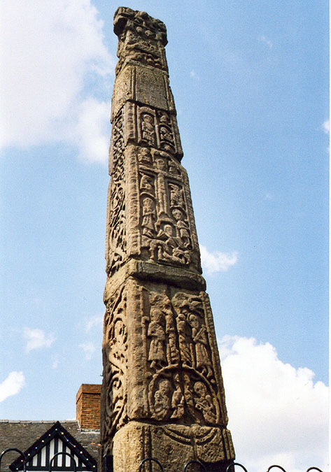 The tallest of the two beautifully decorated market crosses at Sandbach.  It is on the right of the pair when viewed from the south.  The sun highlights the carving on its south front, and west side.  (Orientation calculated by the fact that it was approx 1pm - 2pm on 24th May 2004.)