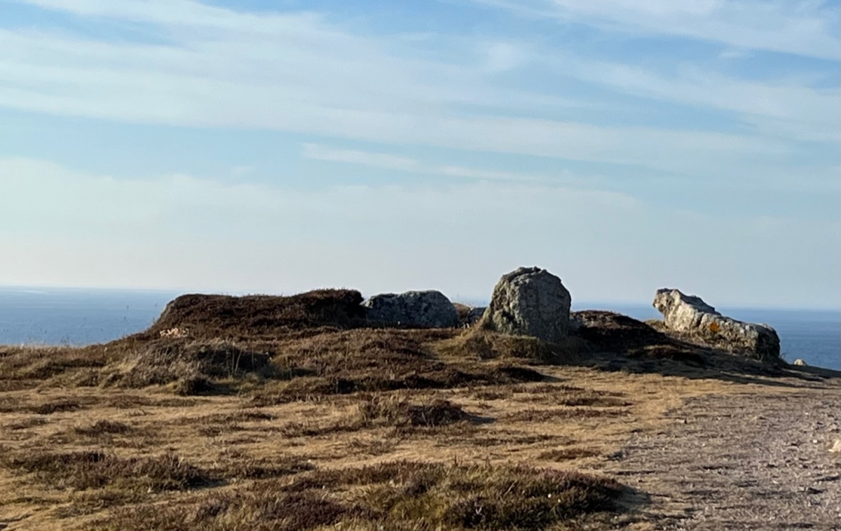 Although this site is interpreted in the descriptions here as a cairn with a central cist (or even double cist) many archaeologists think it more likely that this a damaged Scillonian entrance grave. If viewed in this way the “cist” would be the back of the chamber, the large slab lying towards the east of the cairn a displaced roofstone, and the cairn horseshoe or oval shaped. We know that th