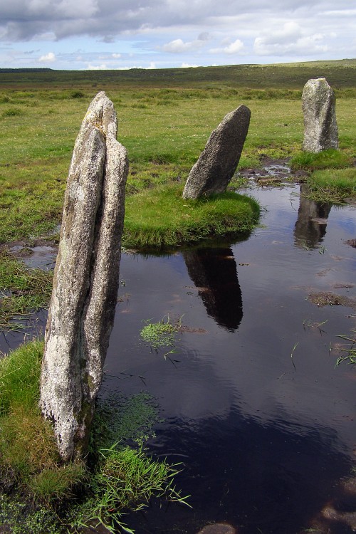 Three of the stones in the south-western quadrant of this restored stone circle. The deep puddles are in holes created by cattle that use the stones as scratching posts - there aren't many trees or fences out here on East Moor.