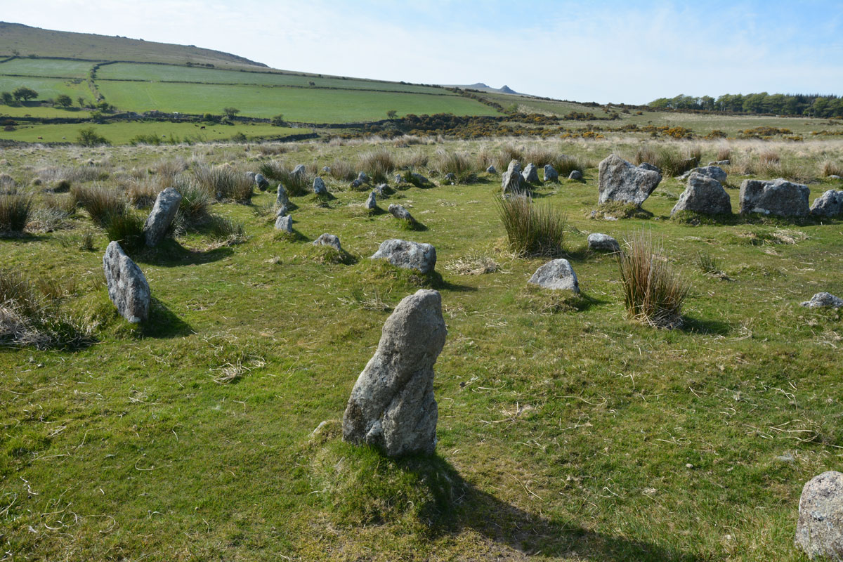 Standing towards the south western side of the outer ring of the stone circle, looking over the western and northern part of the rings (with the central ring just above centre/right), with two distant tors on the distant horizon. We don't have any decent maps of this area, so if any one can identify which tors these are, I'd be grateful to hear. Thanks!