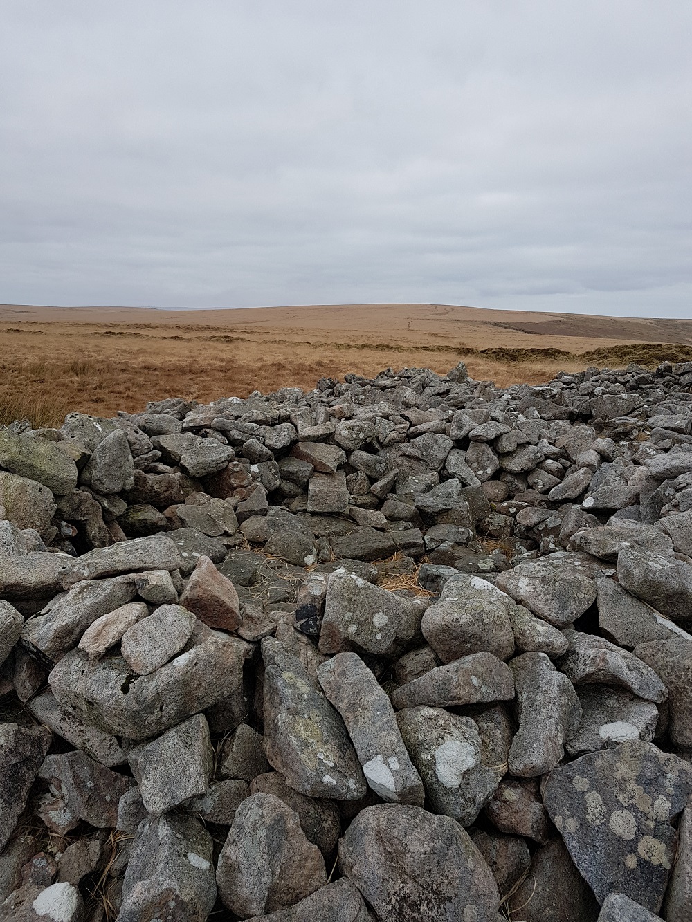 One of the modern day rock shelters built from stones which once formed the original cairn.