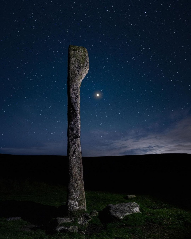 Jupiter glowing bright in the night sky above the magical Drizzlecombe complex in Dartmoor. Also known as the ‘Bone Stone’, it’s one of the most uniquely shaped Menhirs I’ve ever visited, appearing to transform with every step you take around it. 

Photo by Beckie Burr on Instagram, posted with permission.