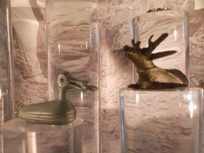 I was thrilled to finally see these two of the threee small figurines 'in the flesh' after writing about them on Meg P.  (An assistant said that the bird must be in storage.)  One can see them in the foyer without paying to enter the rest of the collection.  The display was artfully done, with a selection of finds from the Torbay/South Devon area placed on top of glass columns and nicely lit.
(Th