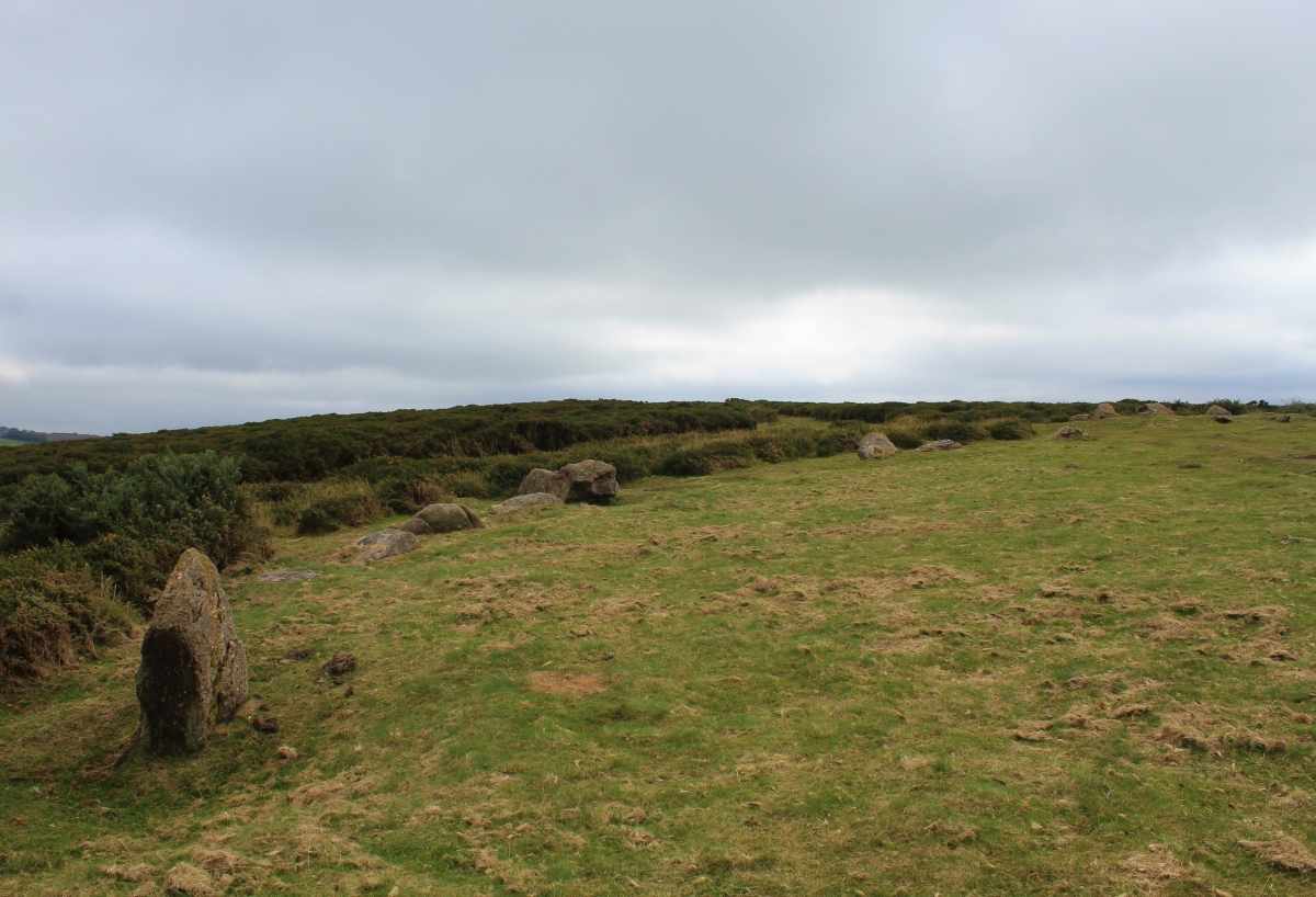 The southern arc of stones from the badly dug into cairn to the big stoney cairn.