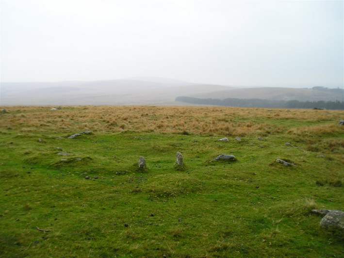 The remains of a hut within the Shovel Down settlement. This hut still has its entrance jambs in place, set side on to the walling. 