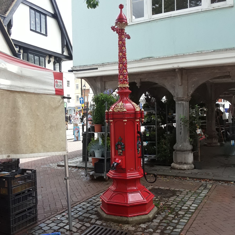 The only pump I can find near this plaque is the Iron Victorian Grade II listed (ID: 1116164) pump in Market Square. 