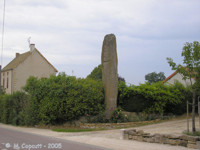 The Pierre-aux-Fées is about 7 metres tall, and has perhaps got some carvings on it. 
