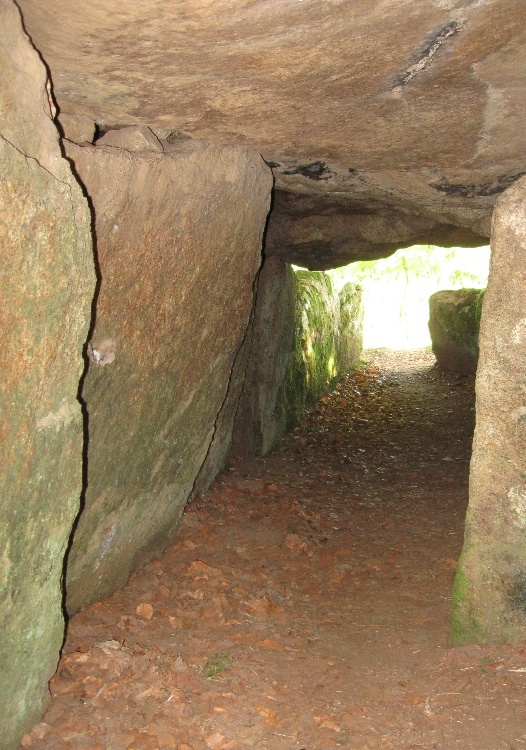 View past the central support pillar towards the inner chamber.  I have cropped this photo to hide the graffiti on the support pillar.  Being located near a village the site is obviously too accessible to such vandals.  Visited in September 2009
