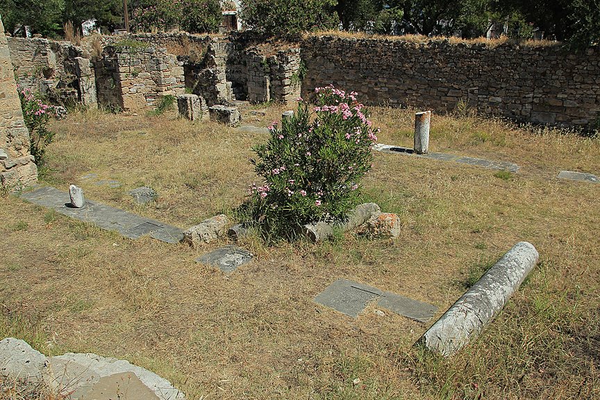 Some pillars in a garden of a church.