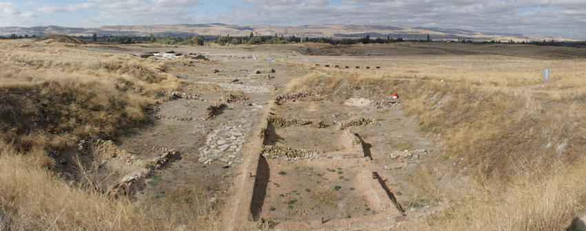 Large Palace.  The large building contemporary with the second building level (1920 - 1840 BCE) was constructed with wooden beams and large mud bricks on stone foundations, it consists of long and narrow store rooms and a central courtyard paved with flat stones.
From the site information board.
