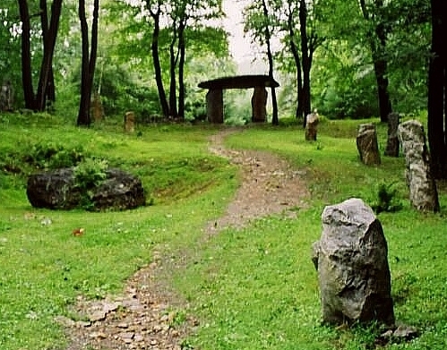 This trilithon, called Thor's Gate, is one of the highlights of Columcille. Other features include a circle of low stones and a construction that gives the appearance of being the entrance to a long barrow. 

There are also two very small chapels, not megalithic, built more on a medieval model. A third chapel, to be built underground, is under construction.