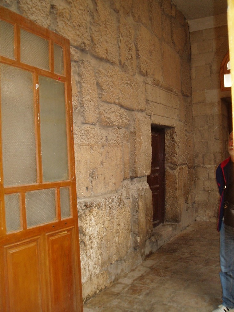 Entrance for sacrificial animals behind the christian facade. The temple started out as a Temple of Baal and then was rebuilt as a Temple of Jupiter-Sol. From about 326 Ce it then progressively became a Greek Catholic church. It now has a false facade and only three column bases are visible. There is an inscription for Emperor Caius Caligula and three niches for Baal statues.
This temple is a lit