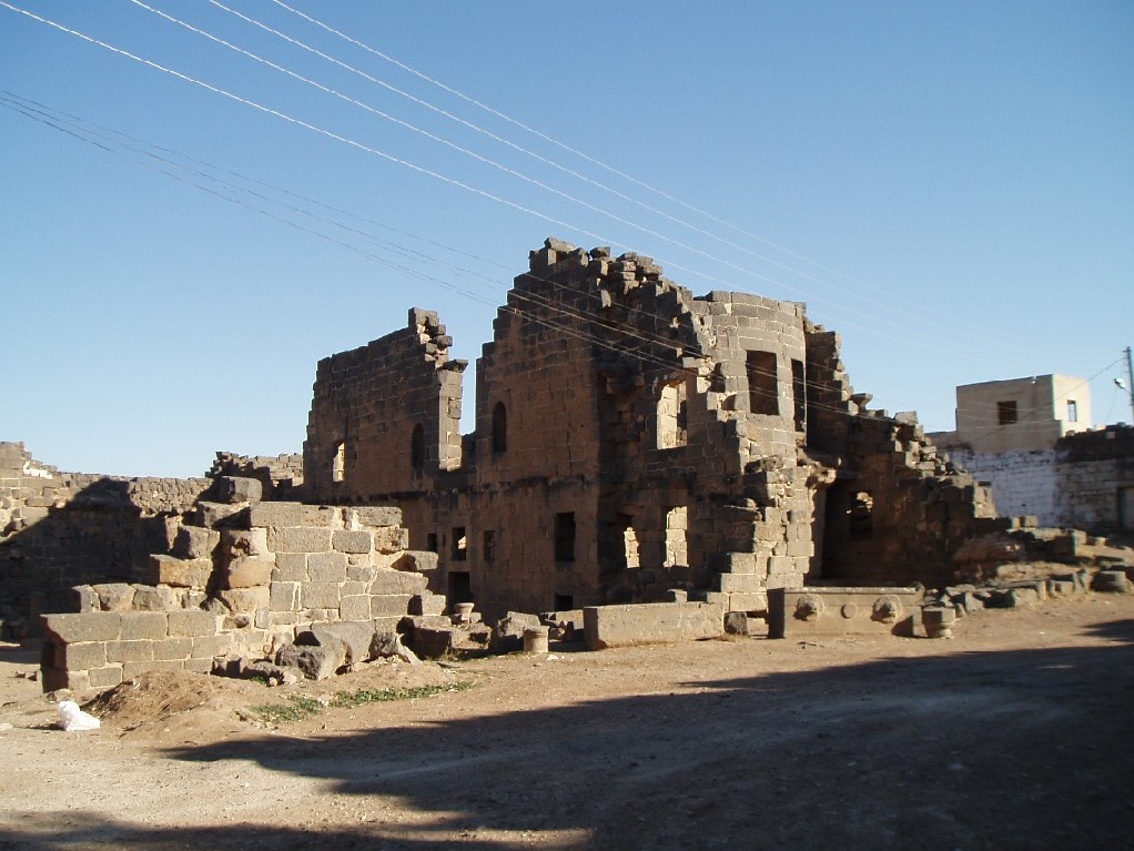 Former Nabatean town, taken over by the Romans. All the buildings are made of black Basalt. Here is Trajan's Palace. 
The city also has a very large reservoir, a theatre, a forum, bath and a colonnade as well as early churches.