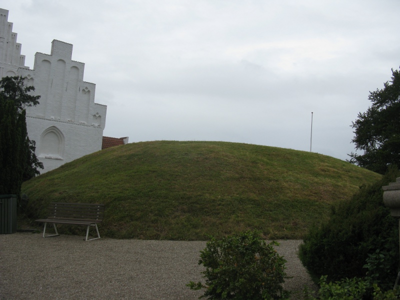 The mound with the church in the background

