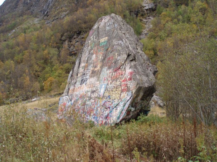This is a picture taken from the west. It shows the flat shape of the boulder.