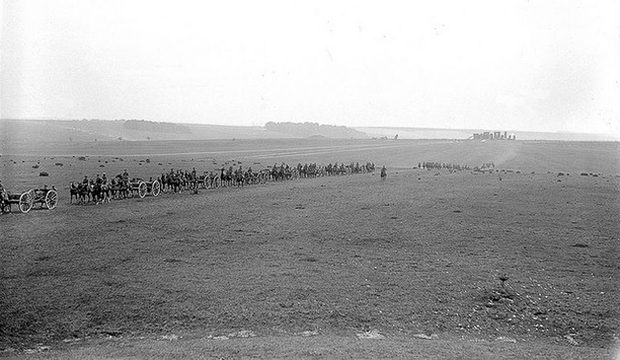 1915
This shot from across the Downs was taken from the rise of the north run on Byway-12, a short distance up from the future A-344. The present Visitor's Center would be off to the right.
In what appears to be early summer we see two Companies of wagons out on the Plain between sprinkled hay bales and grazing sheep. No doubt bound for France, their Captain keeps a close eye on the formation fr