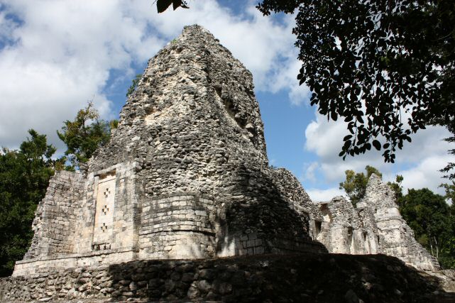 Chicanná Structure I. This imposing building closes the principal plaza of the site on the west side and is the best example of Rio Bec architecture at Chicanná.
The central part of the single storey structure has six rooms arranged in two rows of three rooms each. As one can see it is flanked by two solid towers which remind one of the great pyramidal bases crowned by temples: symbol and synthesis of
