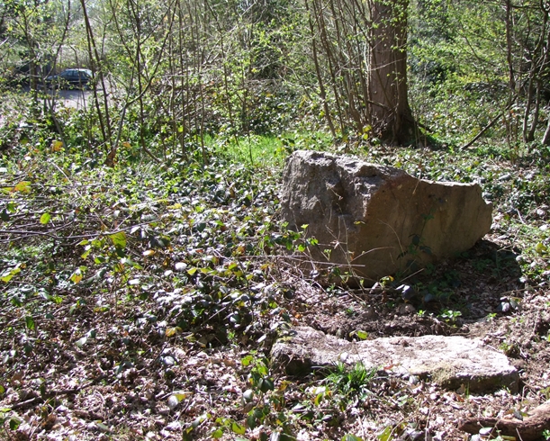 Stones at the edge of the wood.  The car, in the distance, is in front of the cemetery mentionned in the description.  April 2015.