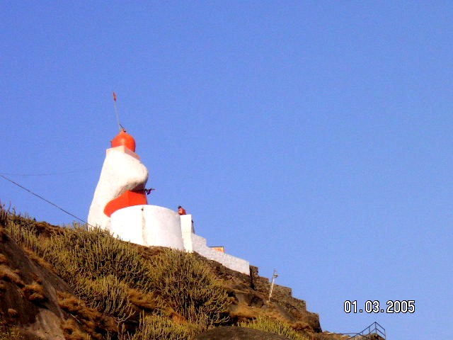 The Guru Shikhar temple at Mout Abu, in Rajasthan, India, was built in a natural rock shelter. The ancient temple has been reconstructed. Its one of the most sacred Pilgrim sites on Mount Abu.