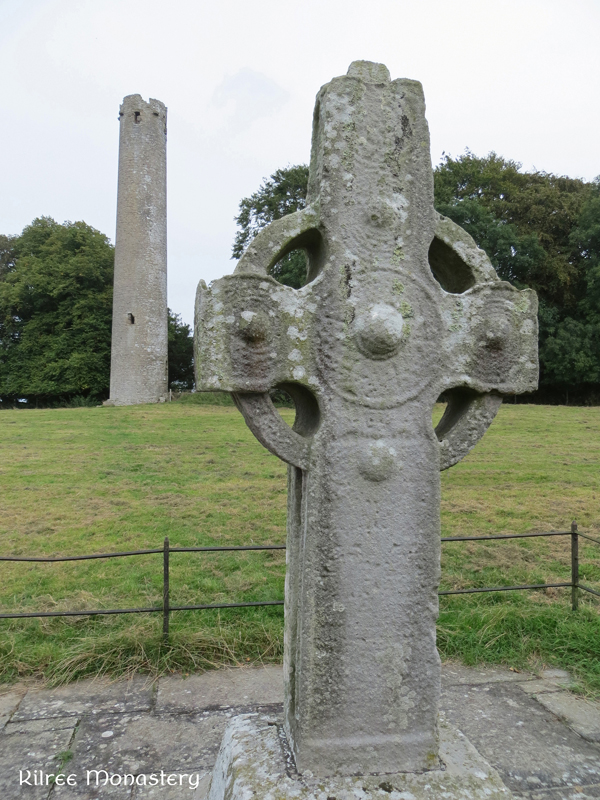 Kilree high cross with the tower of the monastery in the background