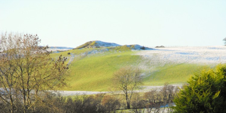 Site in Co. Meath: Loughcrew Cairn L as seen from the path coming down from Cairn T.  The entrance was vividly illuminated in the sunlight.
