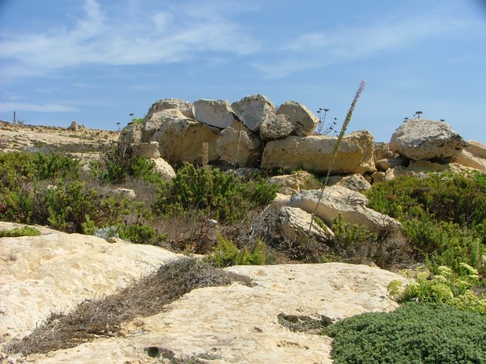 View from the north. In the foreground is one of the Id-Dwejra Cart Ruts.