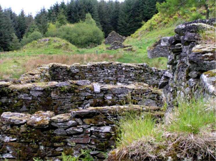 Deserted Kilmory Oib village with cross showing behind the reeds and to the left of the distant ruin.  Some of the ruins have been used more recently as sheep folds.  Kilmory Oib can be translated as ‘Chapel of Maelrudha’, an 8th century saint, or ‘Chapel of Mary’, depending on the emphasis.