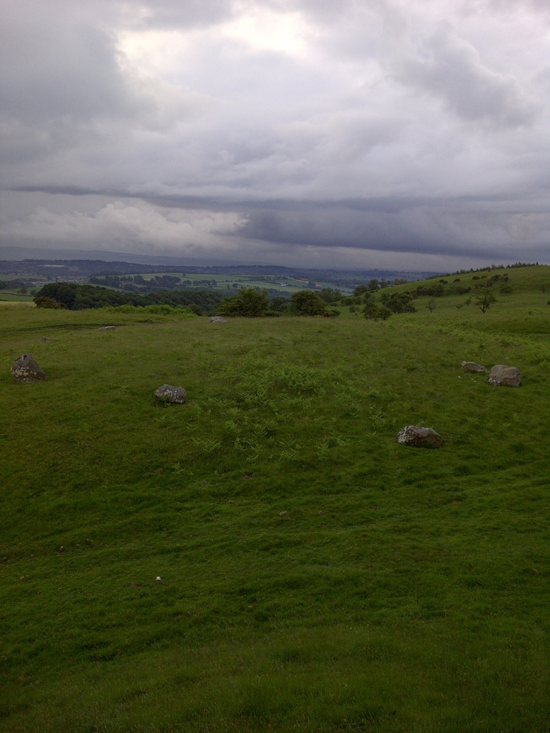 This  small stone circle setting on top of a group of hills called Easthill, it is commonly known as Seven Gray Stones or Seven Gray Stanes which is a misconception has it has ten stones and a diameter of 23 meter's in a slight elliptical shape.
	 The Circle is sitting on top of a grassy knoll over looking Dumfries with a commanding view of the North, East and South. The Circle itself is made up 