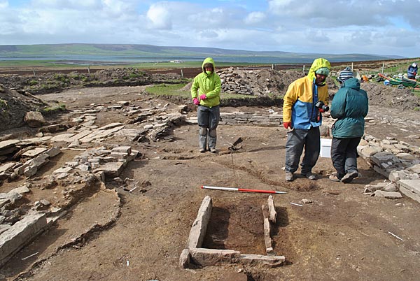 Hearth with older hearth cut mark visible. Also visible are some of the small drainage channels in the floor.

Image credit: Chris Gee